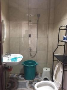 a bathroom with a shower and a toilet and a sink at Cebu City 3 bedrooms split house 2nd floor-WIFI in Cebu City
