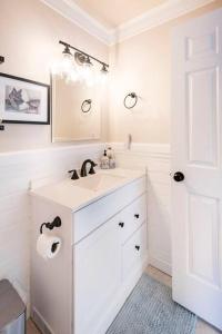 a white bathroom with a sink and a mirror at Murphys Wine Country Getaway in Murphys