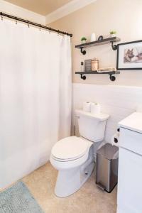 a bathroom with a white toilet and a shower curtain at Murphys Wine Country Getaway in Murphys