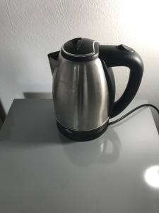 a black and silver tea kettle sitting on a table at Factory in Athens