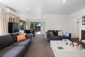 a living room with a couch and a table at Wander into Wanaka in Wanaka
