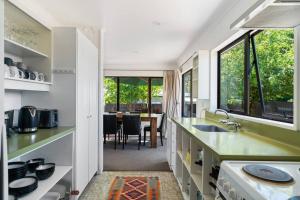 a kitchen with green countertops and a dining room at Wander into Wanaka in Wanaka +5 photos