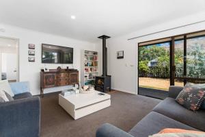 a living room with a couch and a table at Wander into Wanaka in Wanaka
