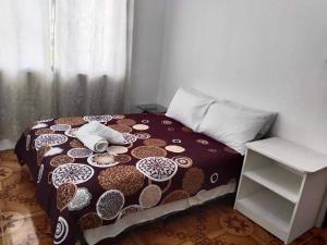 a bedroom with a bed and a white table at Cebu City 3 bedrooms split house 2nd floor-WIFI in Cebu City