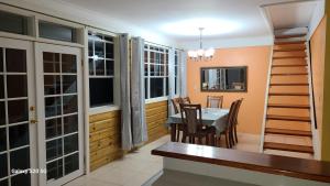 a kitchen and dining room with a table and chairs at Valley View in Roseau