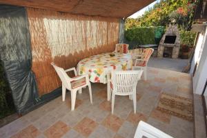 a patio with a table and chairs and a fireplace at Apartments with a parking space Fazana - 7230 in Marana