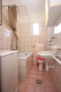 a white bathroom with a sink and a toilet at Apartments with a parking space Fazana - 7230 in Marana
