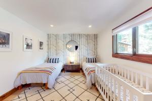 a bedroom with two beds and a mirror at Pine Haven Retreat in Stateline