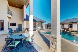 a patio with a table and chairs next to a pool at Lubbock Luxury Living in Lubbock