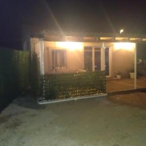 a house at night with the lights on at Holiday house with a parking space Drage, Biograd - 21287 in Pakoštane