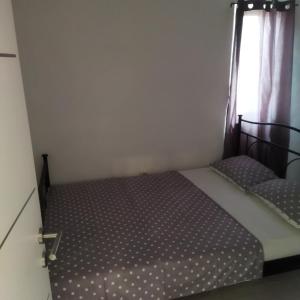a small bedroom with a bed and a window at Holiday house with a parking space Drage, Biograd - 21287 in Pakoštane +6 photos