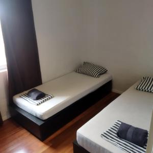 two twin beds in a room with at Holiday house with a parking space Drage, Biograd - 21287 in Pakoštane