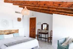 a bedroom with a bed and a desk in a room at Can Colom in Banyalbufar