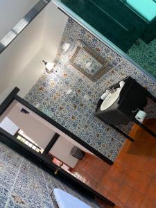 a bathroom with a sink and a bird on the wall at Casa Yollotzin in Ajijic