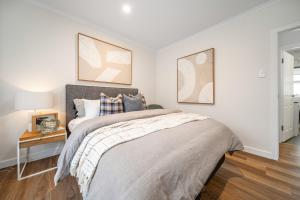 a bedroom with a large bed and a table at The Tea House - Apartment 1 in Keswick