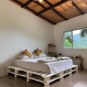 a bedroom with two beds in a room with a window at Eco-ConsciousOasis Punta Arena03 in Playa Punta Arena