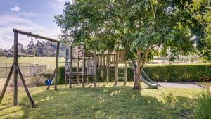 a playground with a tree and a swing at Heritage Holiday House No.15 in Wonga Park