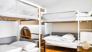 a dorm room with bunk beds and a chair at Heritage Holiday House No.15 in Wonga Park +29 photos