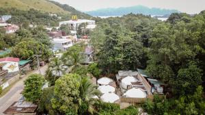 an aerial view of a town with trees and buildings at Nomad Yurts in Coron