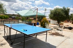 una mesa de ping pong azul con sombrilla en cuchi-barco, en Madrid