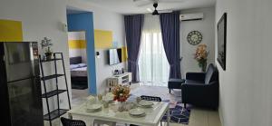 a living room with a table and a living room with a couch at 2 Bedroom with Balcony Nearest KLIA in Sepang