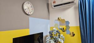 a wall with a clock and a vase on it at 2 Bedroom with Balcony Nearest KLIA in Sepang +3 photos