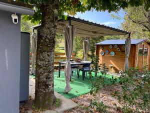 a patio with a table under a canopy at Baiona Valley Hideaway Near Beach in Baiona