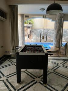 a pool table in the middle of a room at The Glasshouse Pools in Cairo