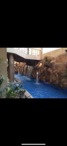 a water park with a bridge and a waterfall at The Glasshouse Pools in Cairo