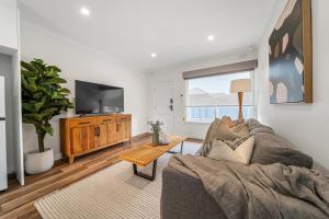 a living room with a couch and a tv at Three Tea House - Relaxed Living in Mile End in Keswick
