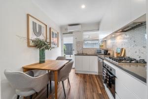 a kitchen with a wooden table and chairs and a counter at The Tea House - Apartment 3 in Keswick