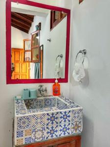 a bathroom with a sink and a mirror at Hotel Al Sole in León