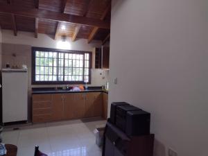 a kitchen with wooden cabinets and a television in it at Casa Obrien in Barraquero