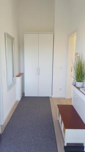 a large room with white closets and a table at Ferienwohnung Hoherting in Prien am Chiemsee