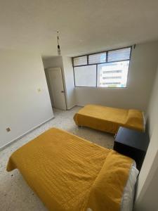 Postel nebo postele na pokoji v ubytování BaW Mateos 809P