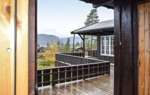 a balcony of a house with a view of the mountains at Cozy Home In Fyresdal With House A Mountain View in Fyresdal