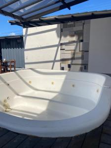 a white bath tub sitting on a deck at hosteline in Villa de Leyva