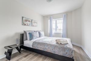 a bedroom with a bed with a dog laying on it at Luxury Town close to Fairview Casino in Niagra Falls in Niagara Falls