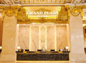 a grand plaza lobby with a sign on the wall at Grand Plaza Hanoi Hotel in Hanoi