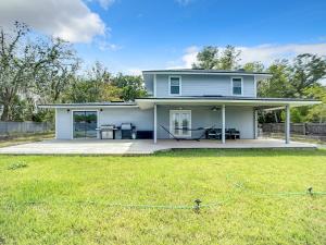 a white house with a patio and a yard at Trout River Oasis in Jacksonville