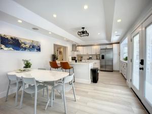 a kitchen and dining room with a white table and chairs at Trout River Oasis in Jacksonville