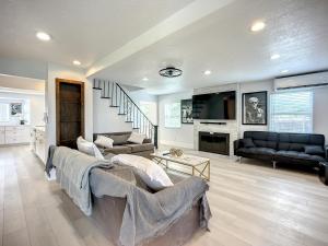 a living room with two couches and a tv at Trout River Oasis in Jacksonville +30 photos