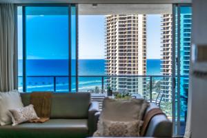 a living room with a couch and a view of the ocean at H-Residences - GCLR in Gold Coast