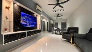a living room with a flat screen tv on a wall at NEW Spacious HAUS 4R 8pax WiF-S Pic-Airport in Bayan Lepas