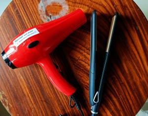 a red pair of scissors and two pens on a table at Smile Hub Kandy in Kandy