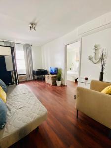 a living room with a couch and a mirror at Ocean Walk by Miami Ambassadors in Miami Beach