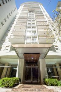 a tall white building with a revolving door at Recoleta Terrace in Buenos Aires