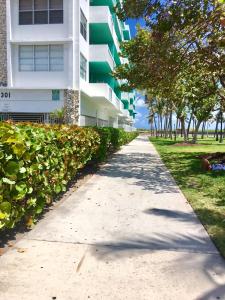 a sidewalk in front of a building at Ocean Walk by Miami Ambassadors in Miami Beach