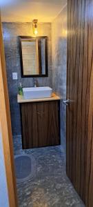 a bathroom with a sink and a mirror and a door at YAXCHILAN 27 in Cancún +15 photos