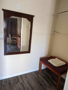 a mirror on the wall of a room with a table at Economy Inn Kingsville in Kingsville